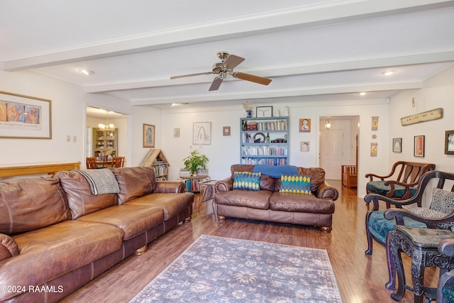 living room featuring beamed ceiling, ceiling fan with notable chandelier, and light hardwood / wood-style floors