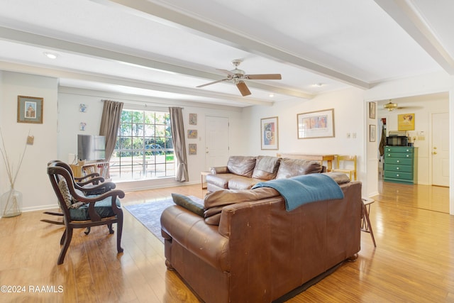 living room with beamed ceiling, light wood-type flooring, and ceiling fan