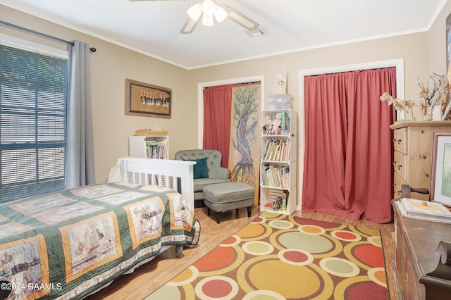 bedroom with ceiling fan, crown molding, and light wood-type flooring