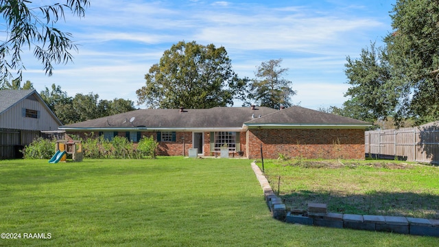 back of property featuring a lawn