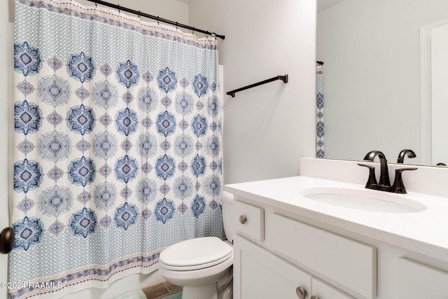 bathroom featuring vanity and toilet