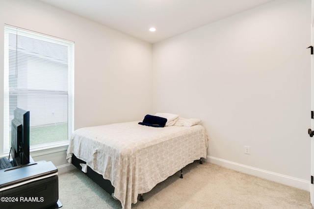 bedroom with light colored carpet