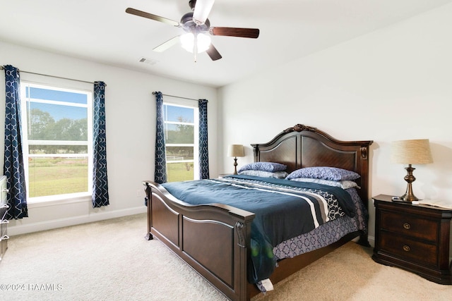 bedroom with light carpet and ceiling fan