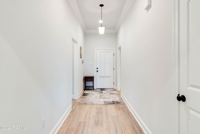 hall featuring light wood-type flooring and crown molding