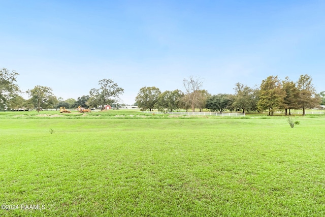 view of property's community with a lawn and a rural view