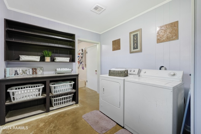 laundry room with washer and clothes dryer and crown molding