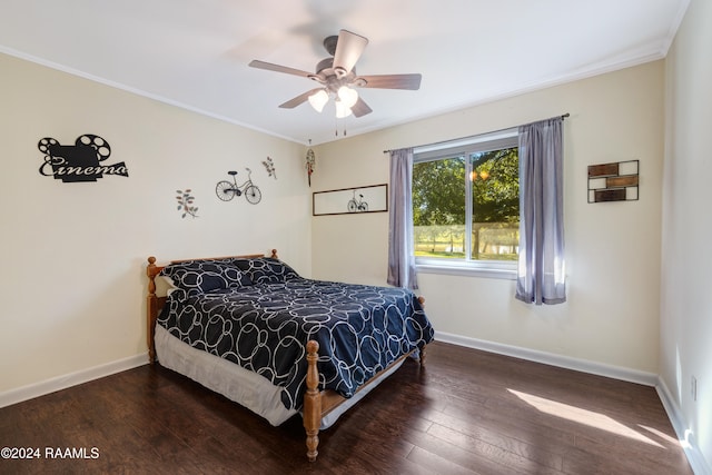 bedroom featuring ceiling fan, crown molding, and dark wood-type flooring