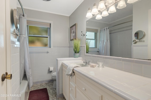 full bathroom featuring vanity, toilet, shower / bath combo with shower curtain, tile walls, and ornamental molding