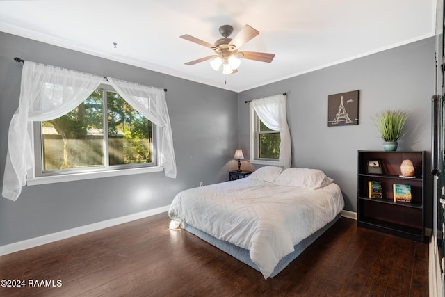 bedroom with ceiling fan, dark wood-type flooring, and ornamental molding