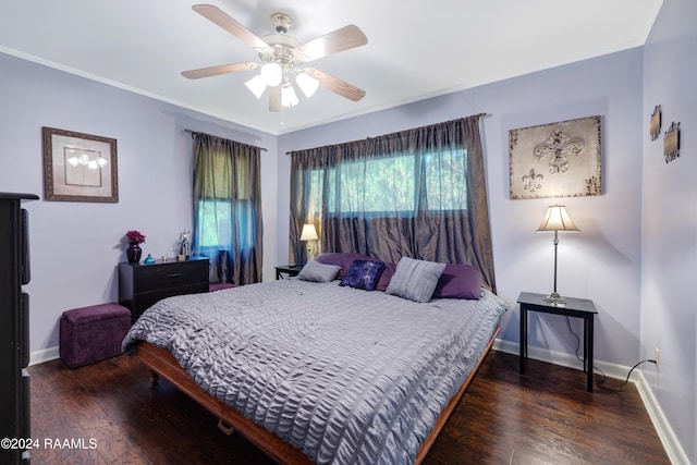 bedroom with dark hardwood / wood-style flooring, ceiling fan, and ornamental molding