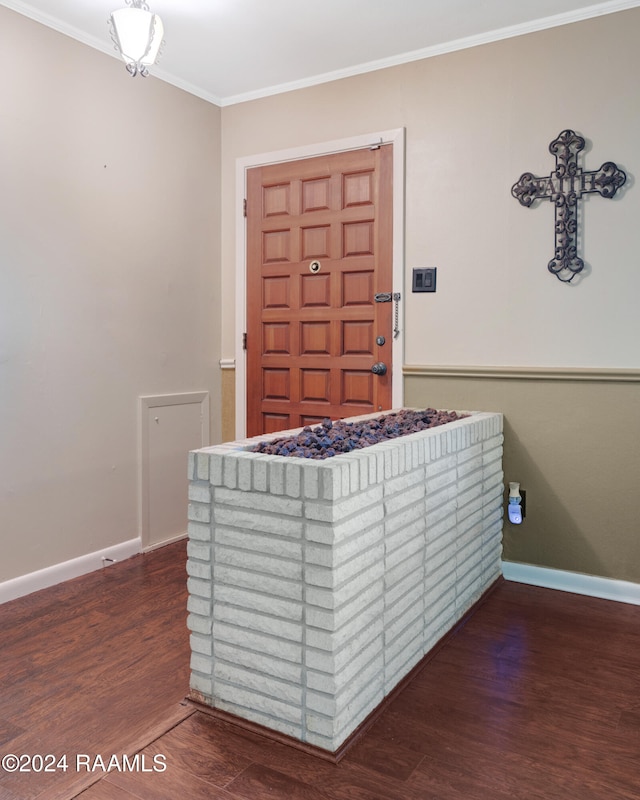 bedroom with dark hardwood / wood-style flooring and crown molding