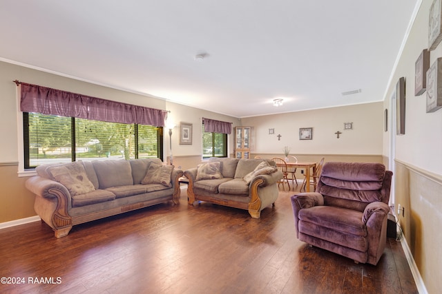 living room featuring a wealth of natural light, dark hardwood / wood-style flooring, and ornamental molding