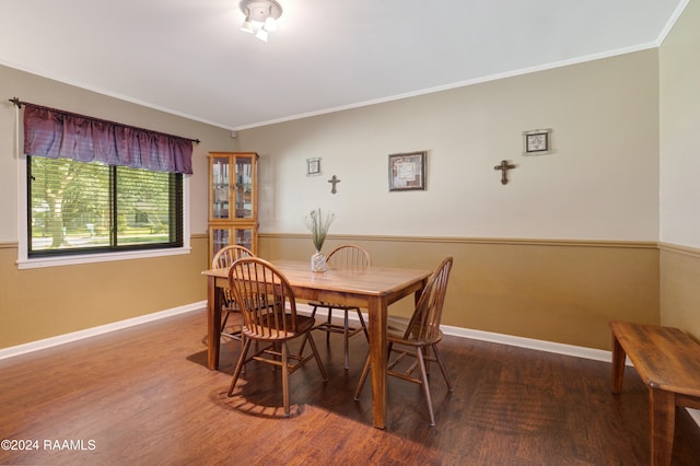 dining room featuring hardwood / wood-style flooring and crown molding