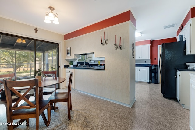 dining space featuring an inviting chandelier, ornamental molding, and sink