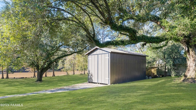 view of outdoor structure featuring a lawn