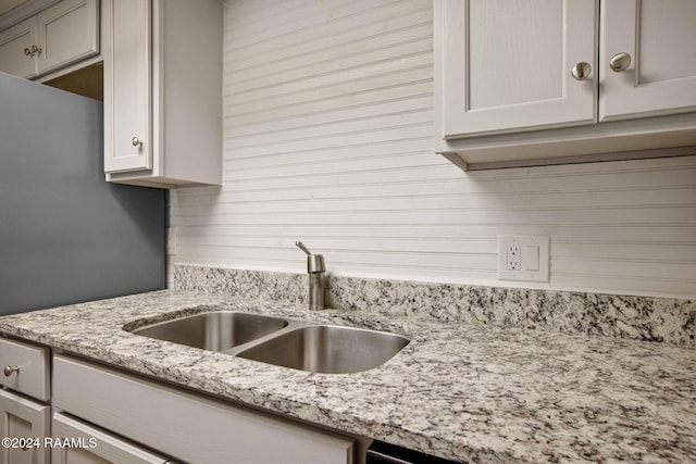 kitchen with light stone countertops and sink