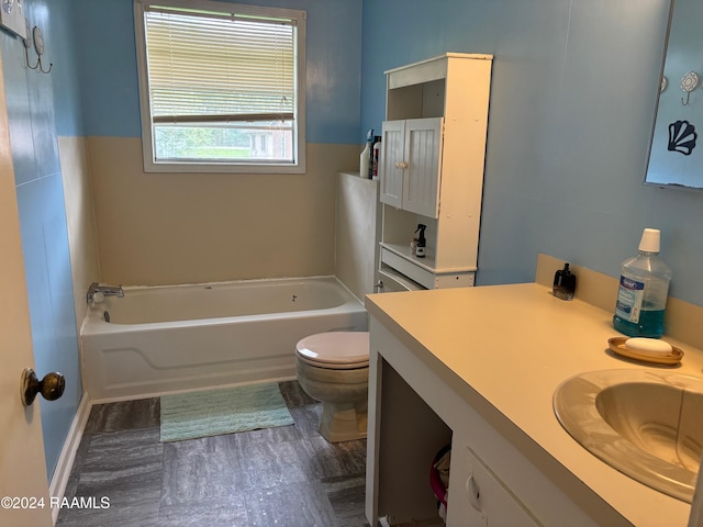 bathroom featuring a washtub, vanity, and toilet