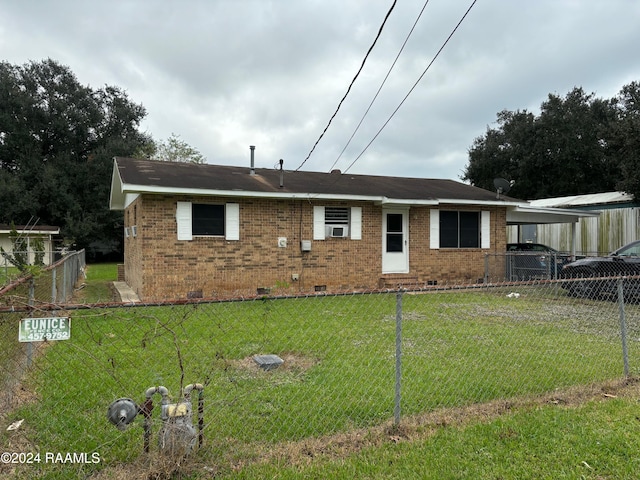 back of property featuring a lawn