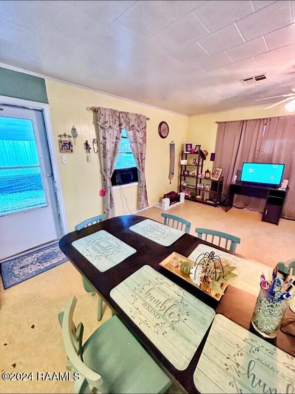 dining room with ceiling fan and carpet floors