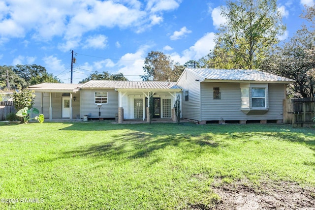 rear view of property featuring a yard