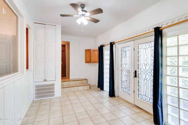 entrance foyer featuring ceiling fan, light tile patterned flooring, and french doors