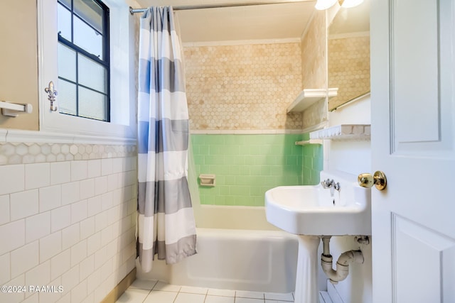 bathroom with tile patterned floors, shower / tub combo with curtain, and tile walls