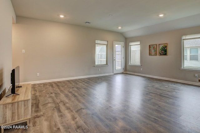 unfurnished living room featuring dark hardwood / wood-style floors, plenty of natural light, and vaulted ceiling