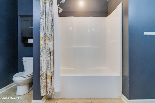 bathroom featuring tile patterned flooring, shower / tub combo, and toilet