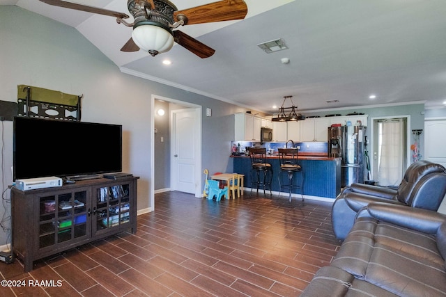 living room featuring lofted ceiling, ceiling fan, dark hardwood / wood-style floors, and ornamental molding