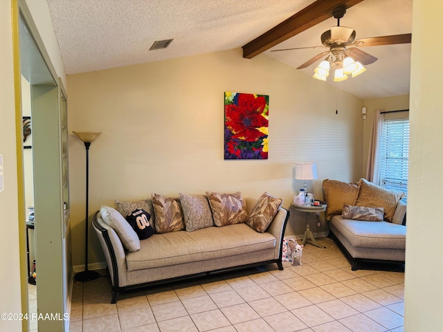 tiled living room featuring vaulted ceiling with beams, ceiling fan, and a textured ceiling