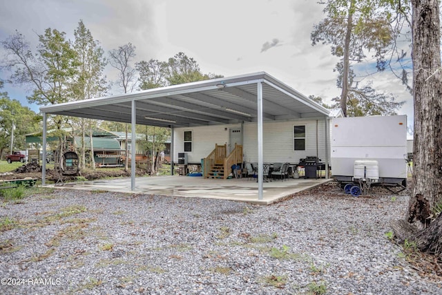 rear view of property featuring a carport