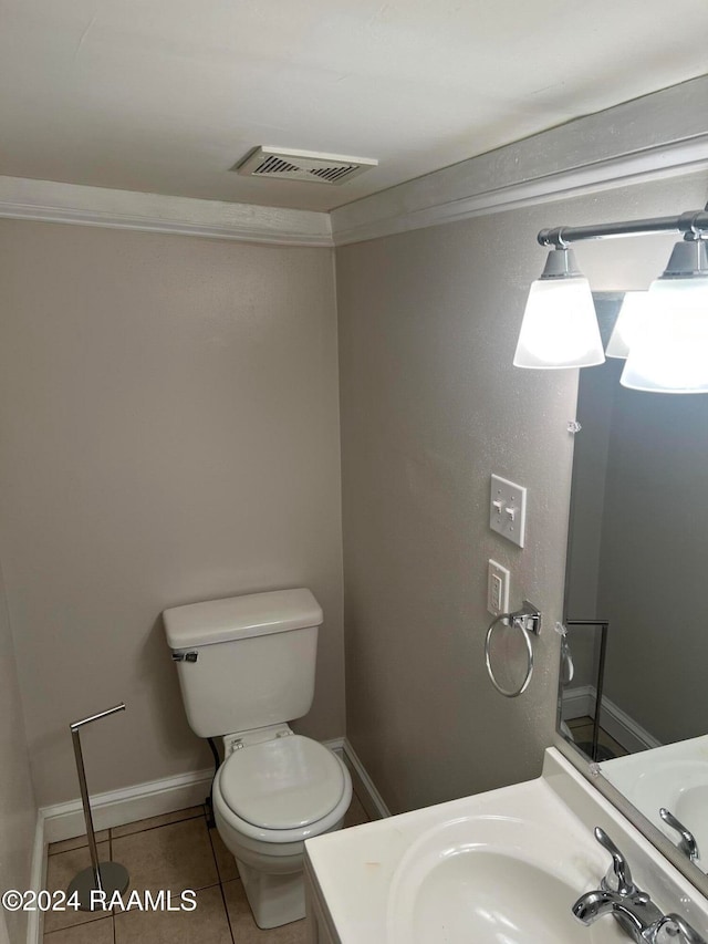 bathroom featuring toilet, vanity, and tile patterned flooring