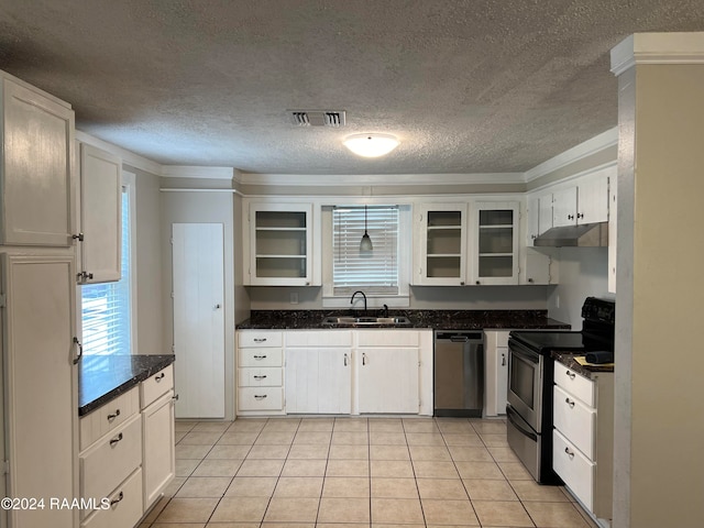 kitchen featuring white cabinets, sink, ornamental molding, light tile patterned flooring, and appliances with stainless steel finishes