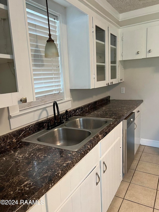 kitchen featuring white cabinets, stainless steel dishwasher, and decorative light fixtures