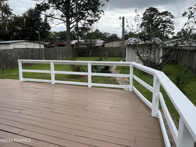 wooden deck featuring a yard