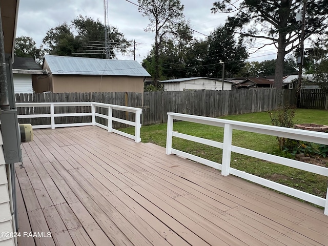 wooden deck featuring a lawn