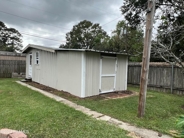 view of outbuilding featuring a yard