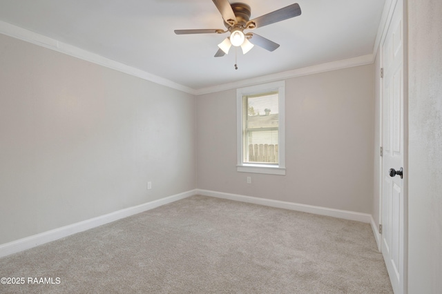 unfurnished room with baseboards, carpet, ceiling fan, and crown molding