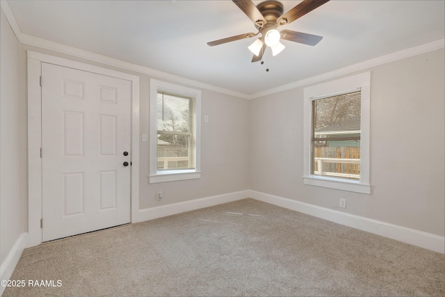 unfurnished room featuring carpet floors, a healthy amount of sunlight, and ornamental molding