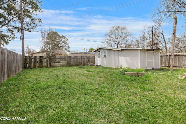 view of yard with an outbuilding, a storage shed, and a fenced backyard