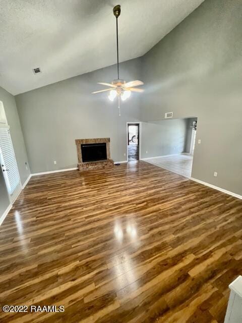 unfurnished living room featuring ceiling fan, high vaulted ceiling, and dark hardwood / wood-style flooring