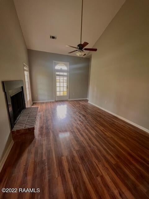 unfurnished living room featuring high vaulted ceiling, dark hardwood / wood-style floors, and ceiling fan