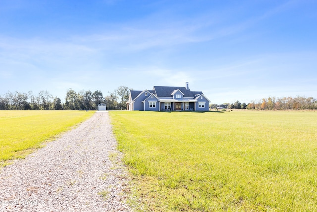 view of front of property featuring a rural view and a front lawn