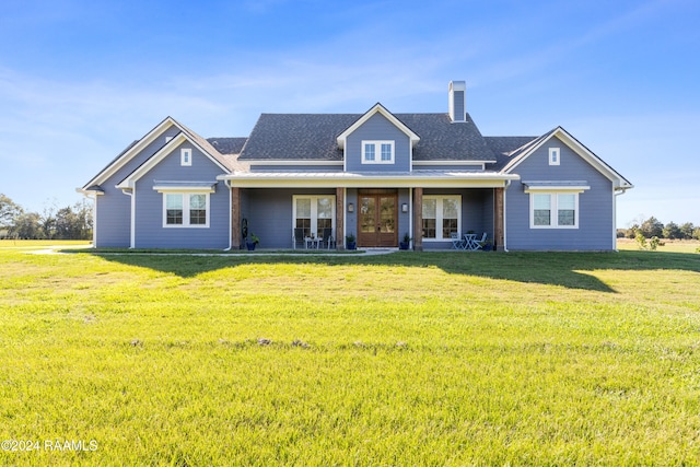 rear view of house featuring french doors and a yard