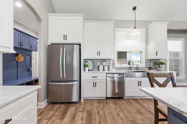 kitchen with white cabinets, hardwood / wood-style flooring, and appliances with stainless steel finishes