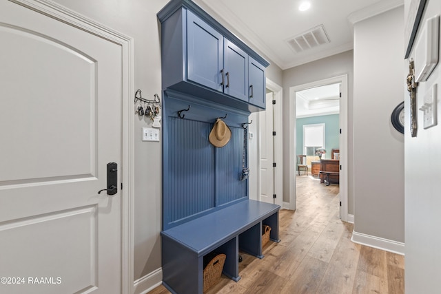 mudroom with light wood-type flooring and ornamental molding