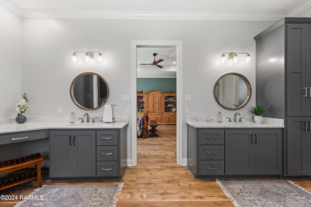 bathroom featuring vanity, hardwood / wood-style flooring, ceiling fan, and crown molding