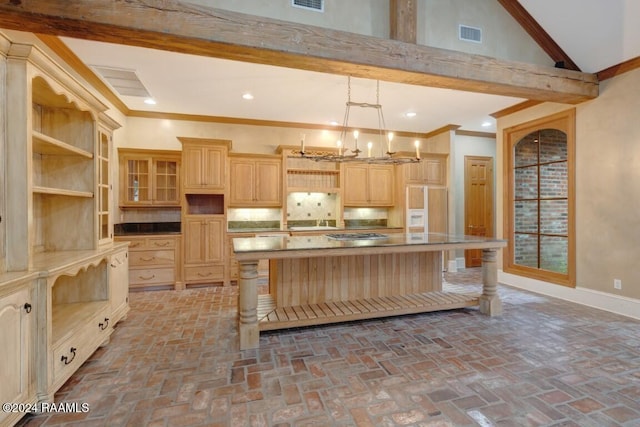 kitchen featuring a kitchen island, decorative light fixtures, light brown cabinetry, decorative backsplash, and a breakfast bar area