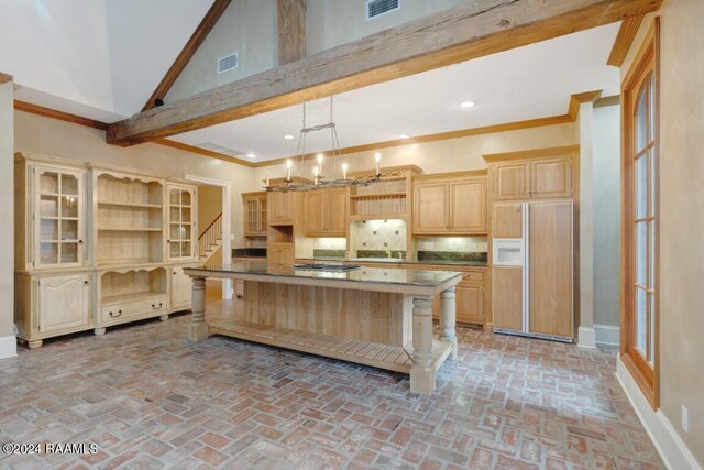 kitchen featuring hanging light fixtures, high vaulted ceiling, paneled built in fridge, and a center island