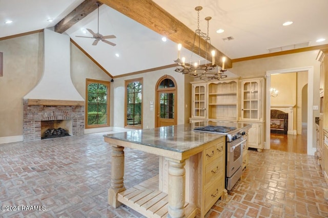 kitchen featuring a breakfast bar, decorative light fixtures, a fireplace, a kitchen island, and high end range